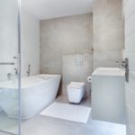 Minimalist design and light neutral colors are the key features of this complete bathroom renovation