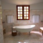 Remodeling contractors in Austin Texas give a rustic touch to the bathroom wiith bright colors.